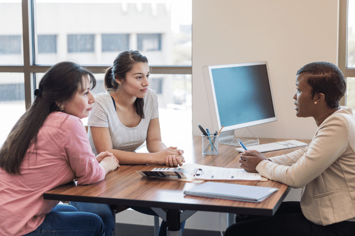 Three women sitting at a table.