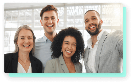 A diverse group of four professionals smiling together, suggesting a friendly and inclusive work environment.